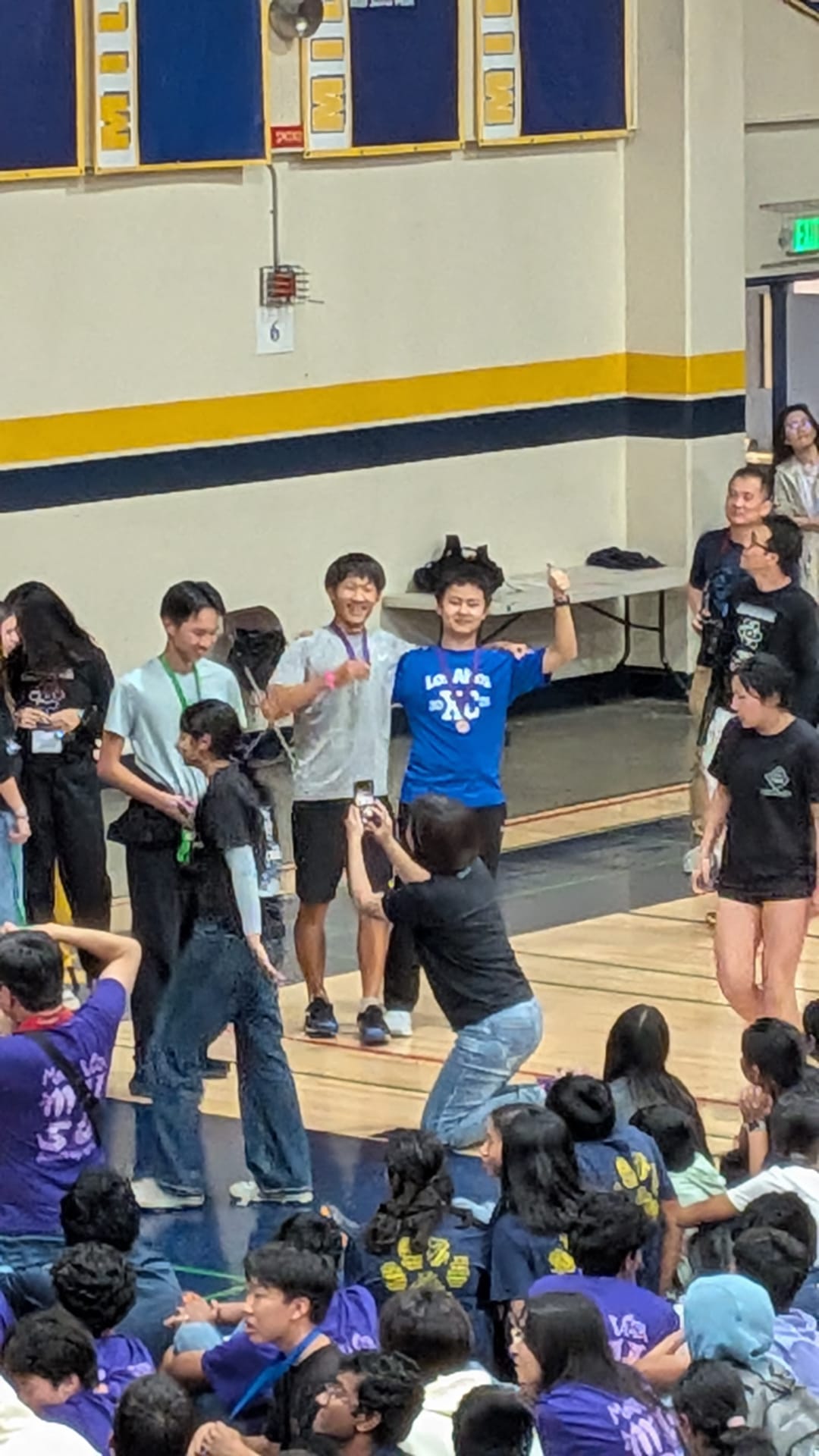 Students at an awards ceremony in a crowded gym