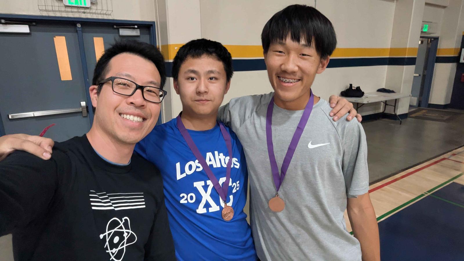 Coach and students with medals